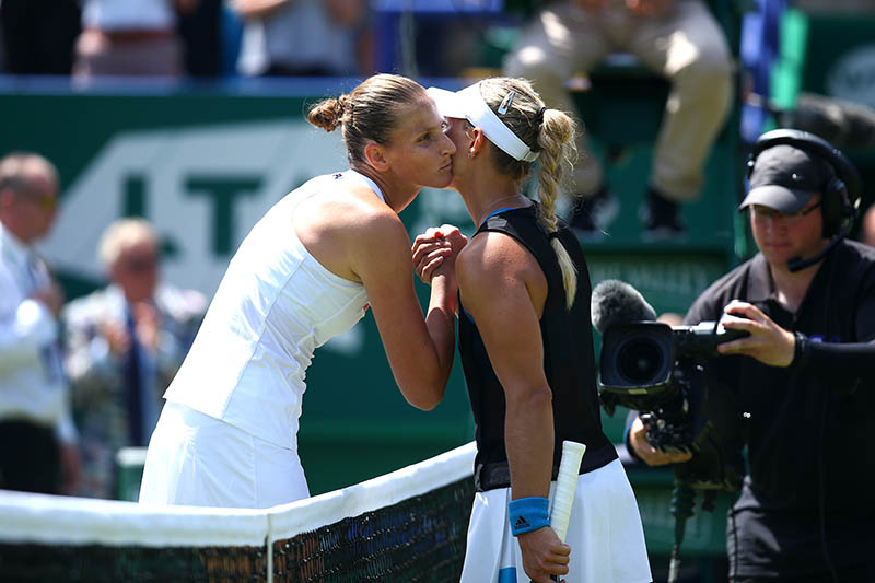 Angelique Kerber and Karolina Pliskova embrace at the net