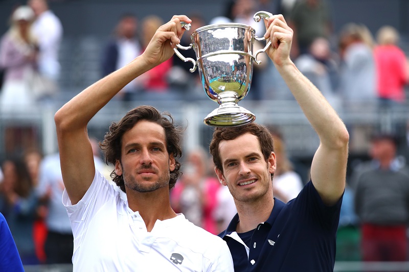 Andy Murray and partner Feliciano Lopez celebrate victory with the winners trophy in the mens doubles final