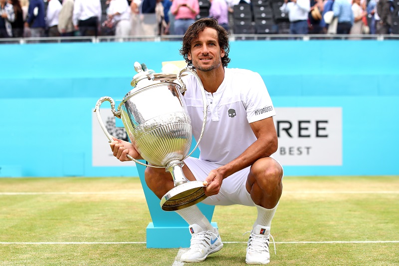 Feliciano Lopez celebrates victory with the trophy during the mens singles final against Gilles Simon